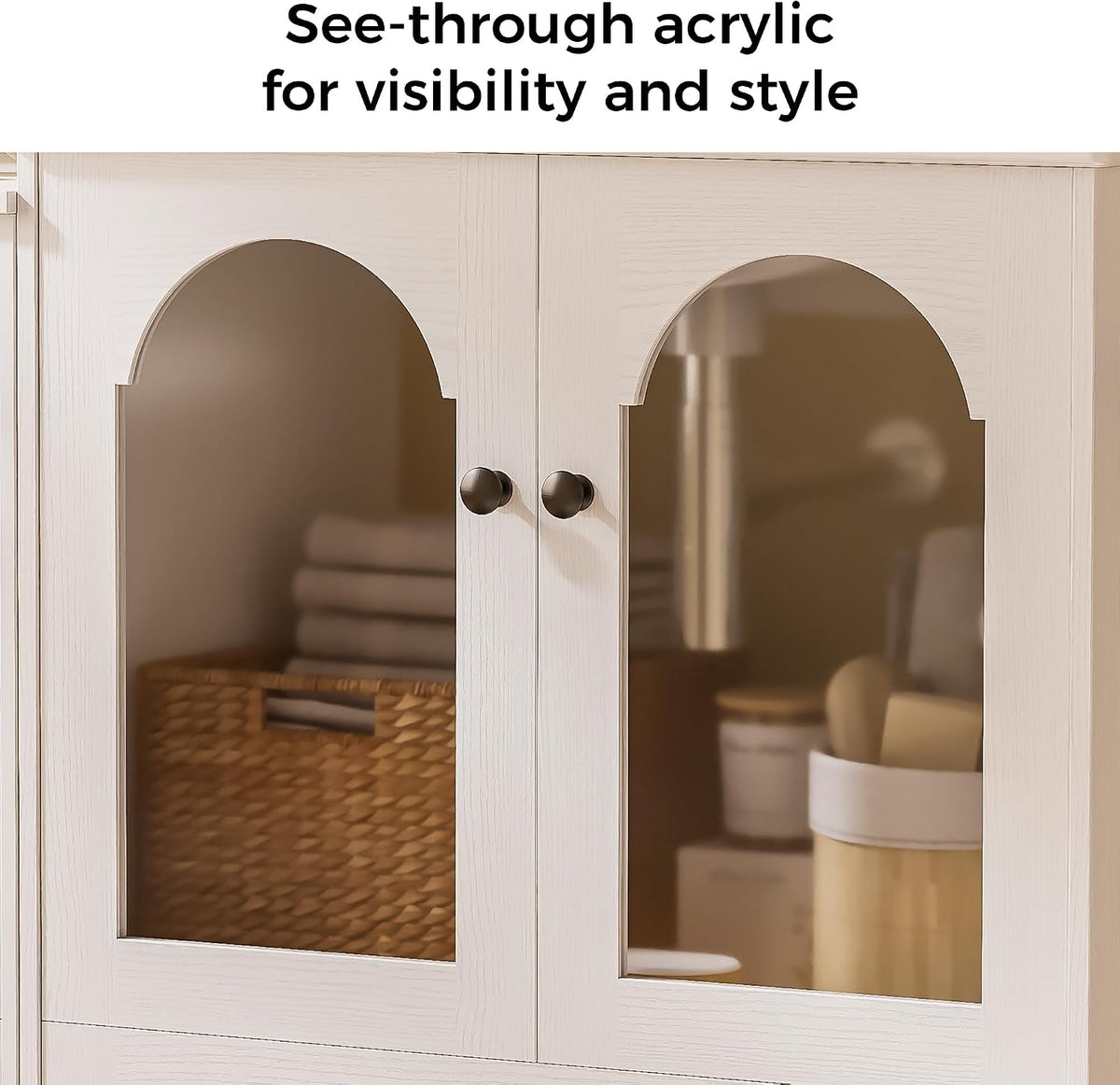 Close-up of two white cabinet doors with arched see-through acrylic panels showing a woven basket and toiletries inside.