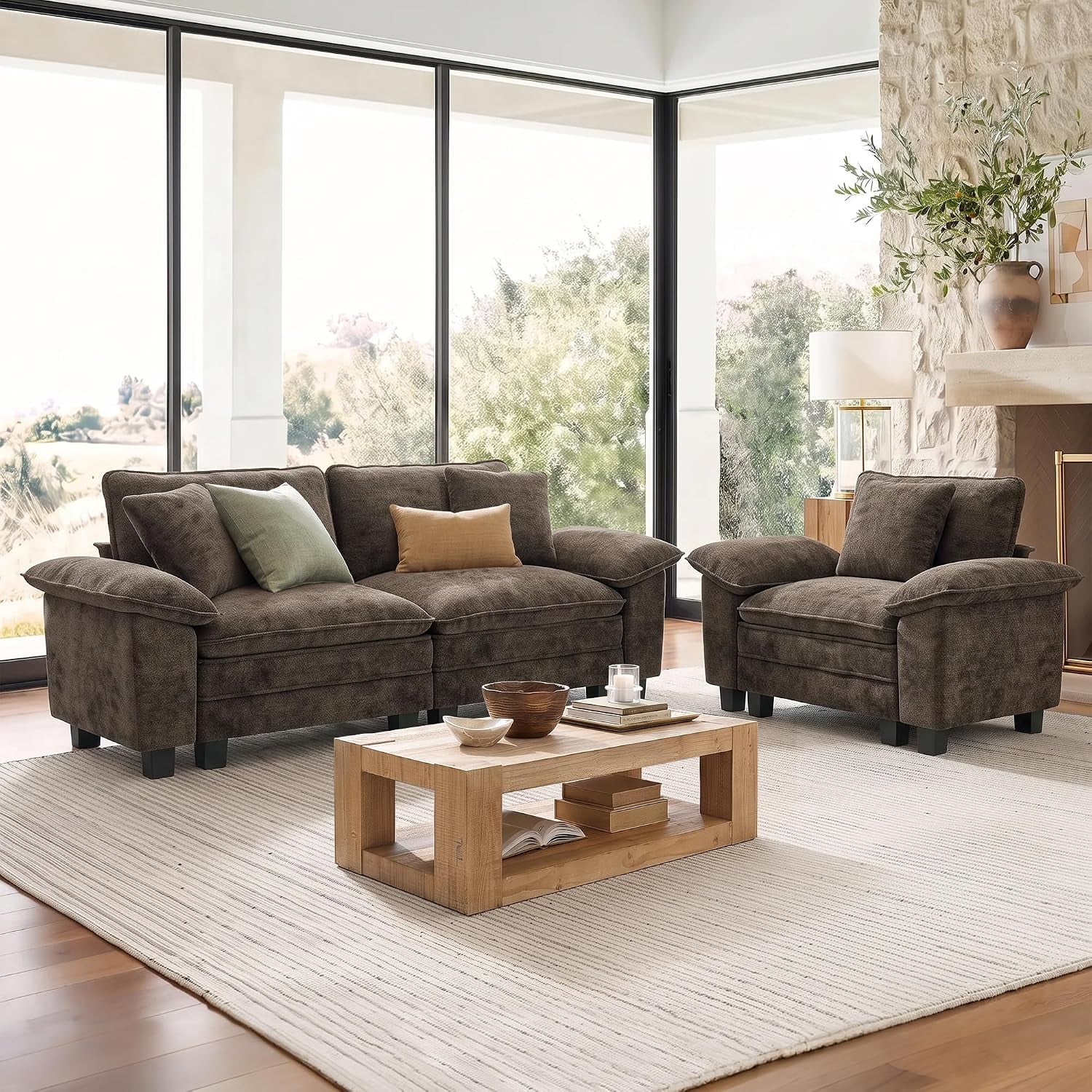 Dark brown three-seat sofa and matching chair beside a wooden coffee table in a bright room.