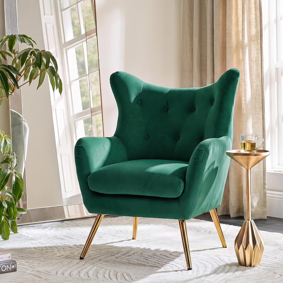 Deep emerald green wingback chair shown from the right, spotlighting tufted back and angled gold legs.
