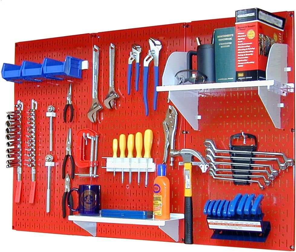 Red metal pegboard mounted with hooks, shelves, bins and hand tools arranged across its surface