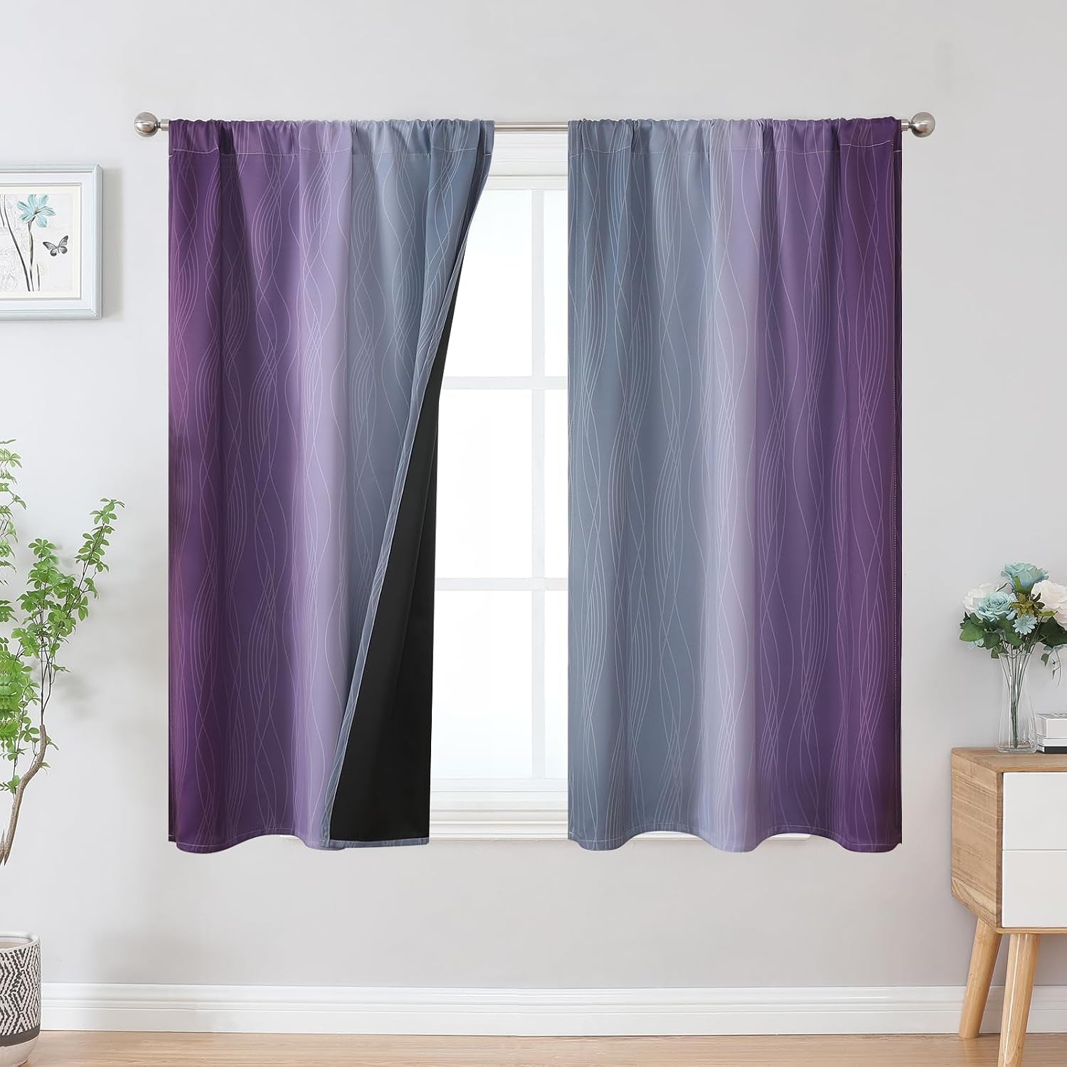 Purple-to-gray ombre curtains with subtle wave pattern, one panel pulled back to reveal black lining and window behind.