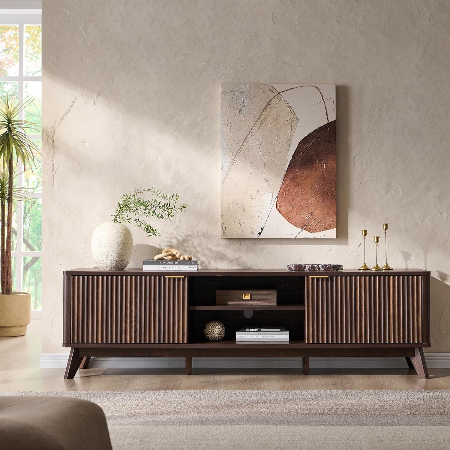 Dark walnut TV stand centered front view with open shelf and fluted cabinet doors under wall art