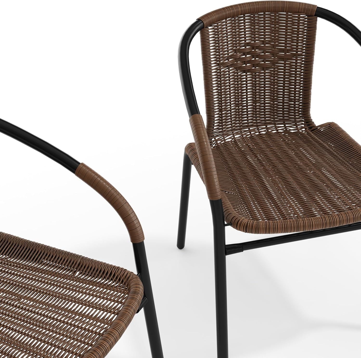 Partial three-quarter view of two brown rattan dining chairs with black tubular frames