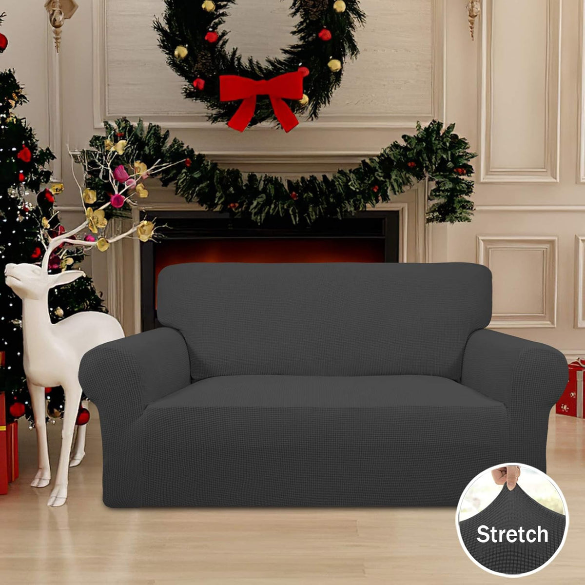 Dark gray slipcover on a loveseat staged with holiday wreath and decorations, with stretch detail inset