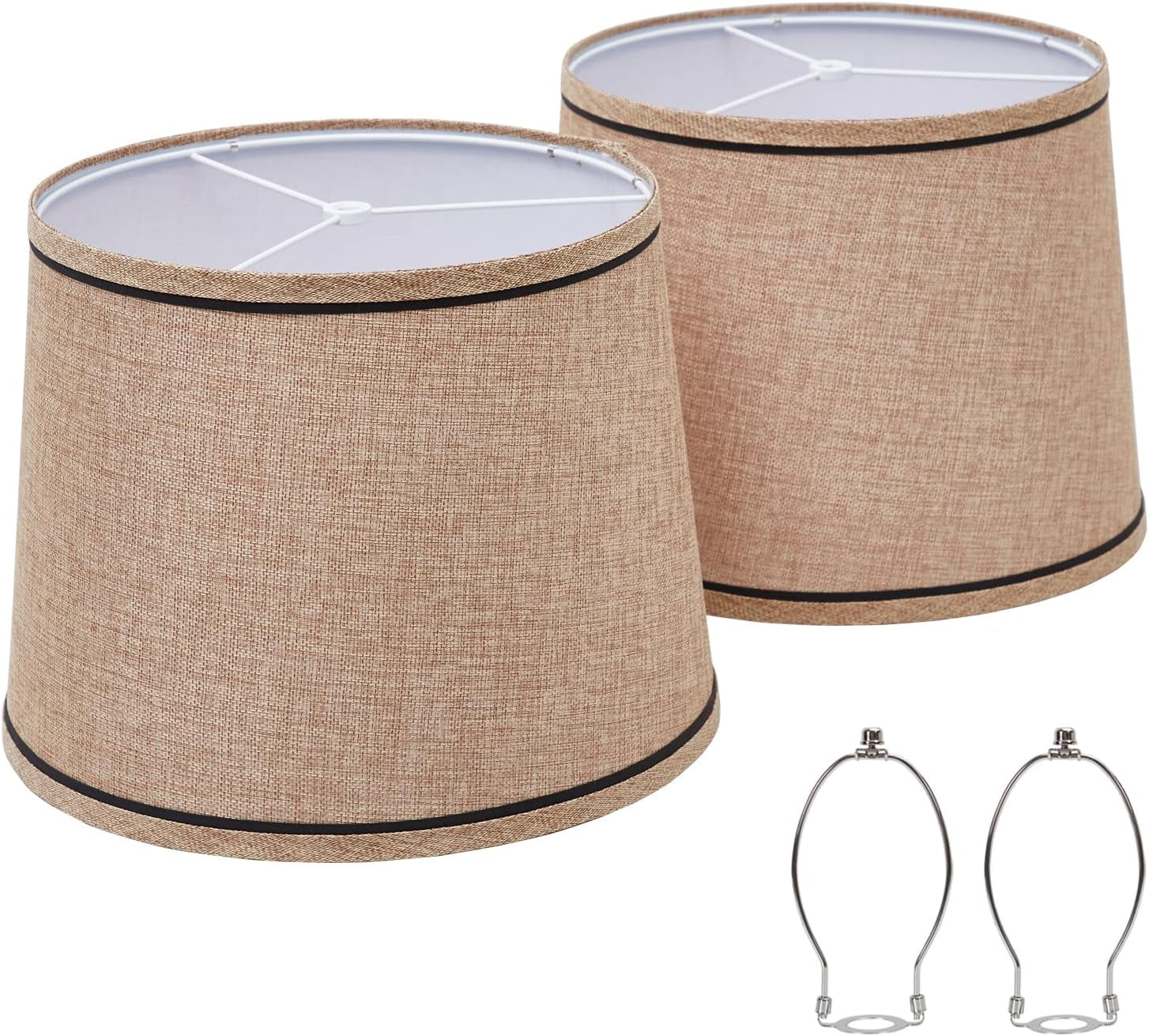 Two tan textured fabric shades with subtle black trim shown with two metal harp fittings at lower right