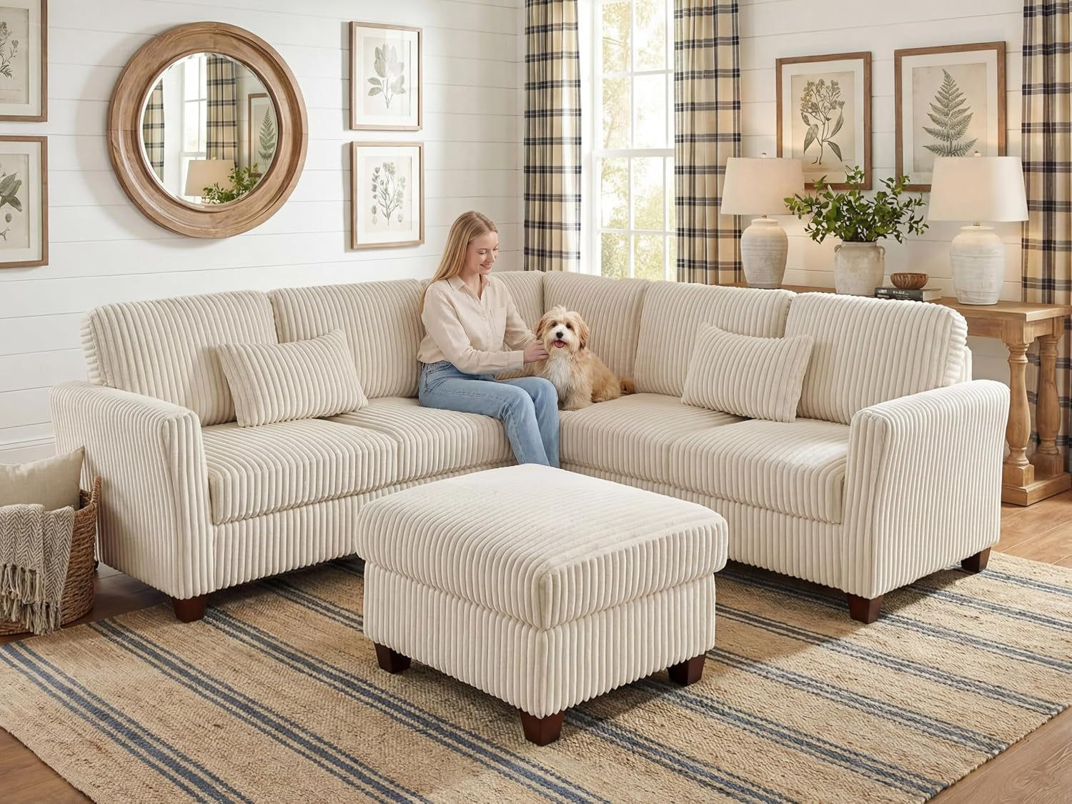 Woman sitting on beige corduroy sectional with dog, ottoman in front, living room setting