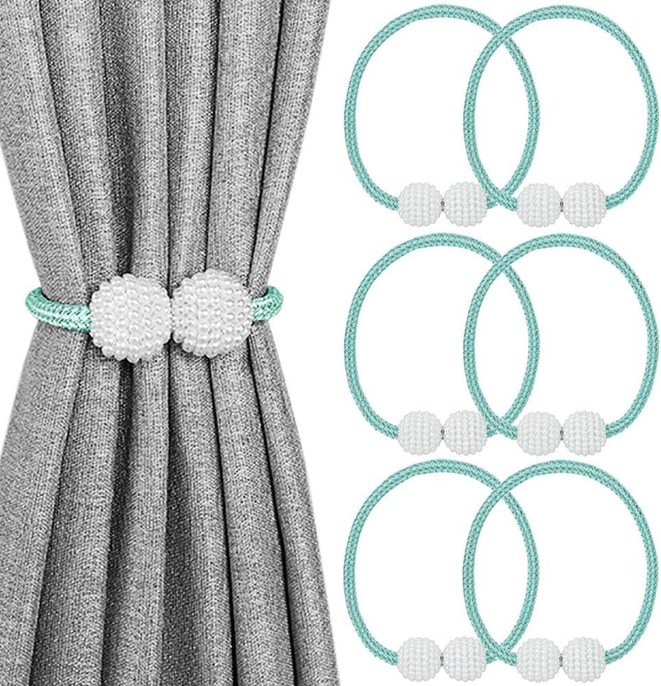 Gray curtain held by a mint green rope tieback with beaded white pearl balls and several matching green rings