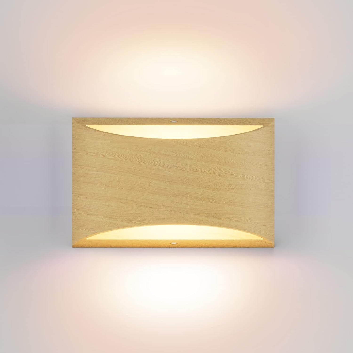 Single rectangular wall light in a light wood finish, casting warm up-and-down illumination on the wall.