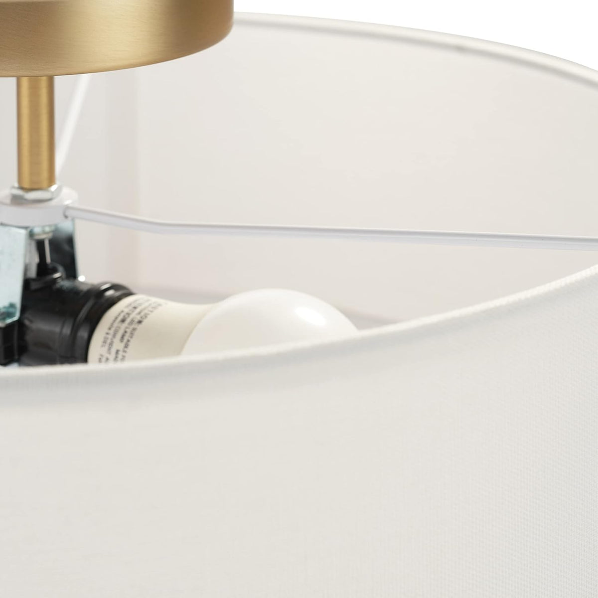 Interior close-up showing an E26 bulb socket, mounting hardware and the white fabric shade edge