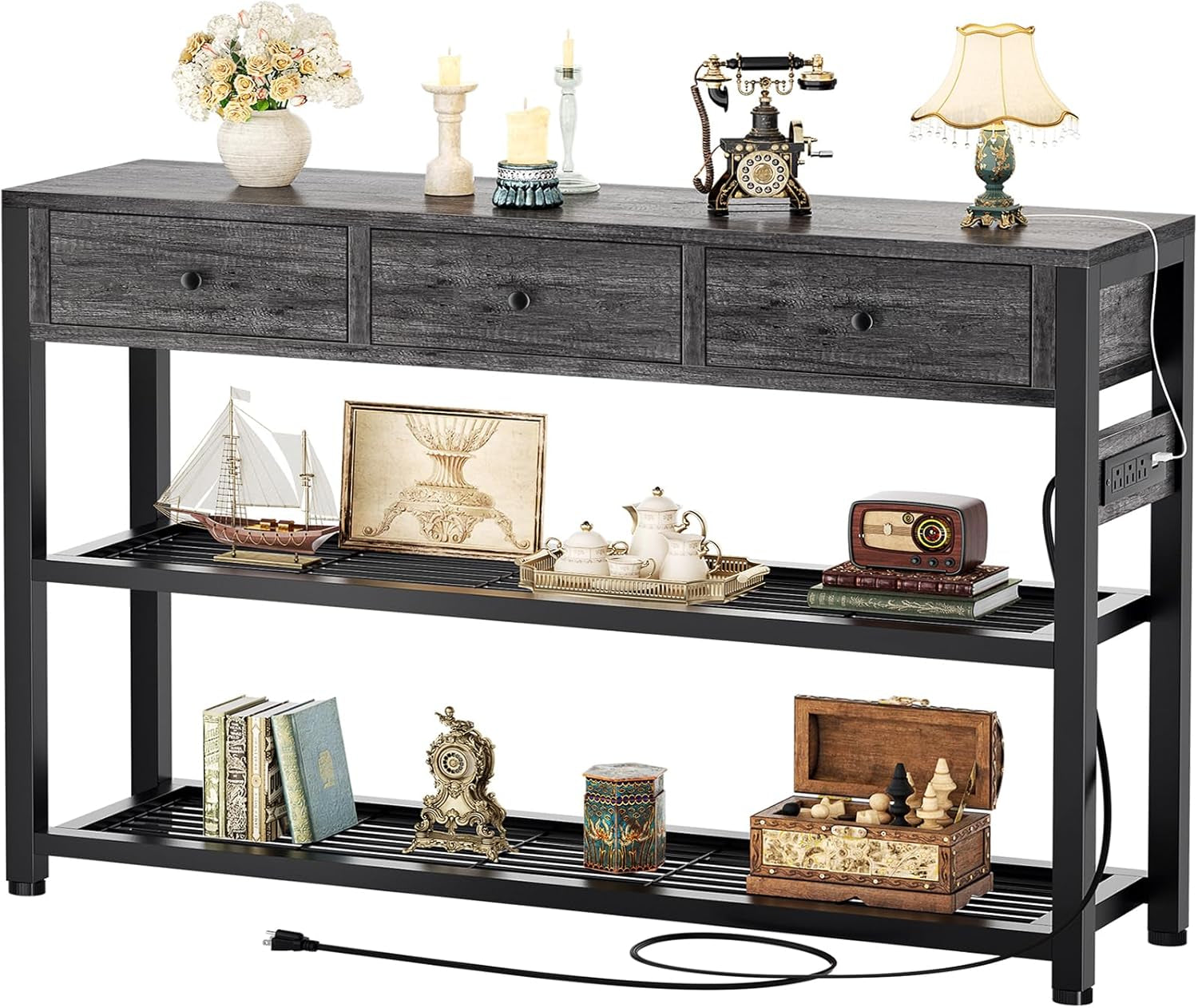 Front view of grey console table on white background showing three drawers, two slatted lower shelves and outlet cord