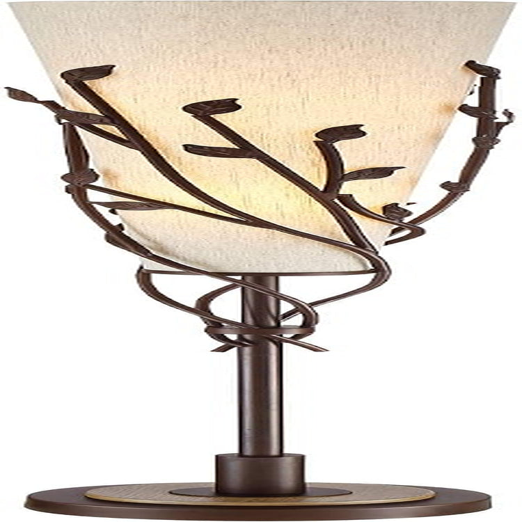 Close-up of lamp midsection showing metal vine-and-leaf motif wrapped around the tapered linen shade