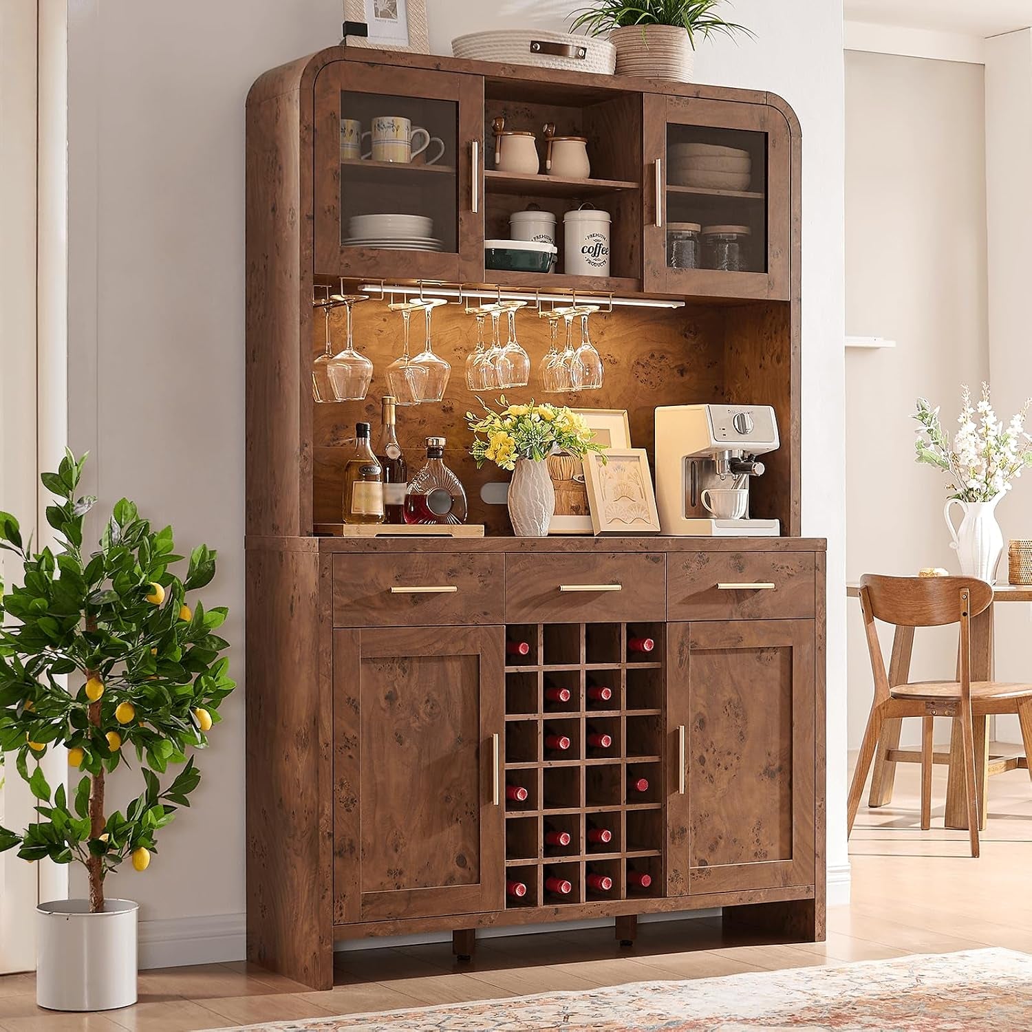 Close view of the cabinet's lower section with a center wine cubby, three drawers and a potted lemon tree beside it.