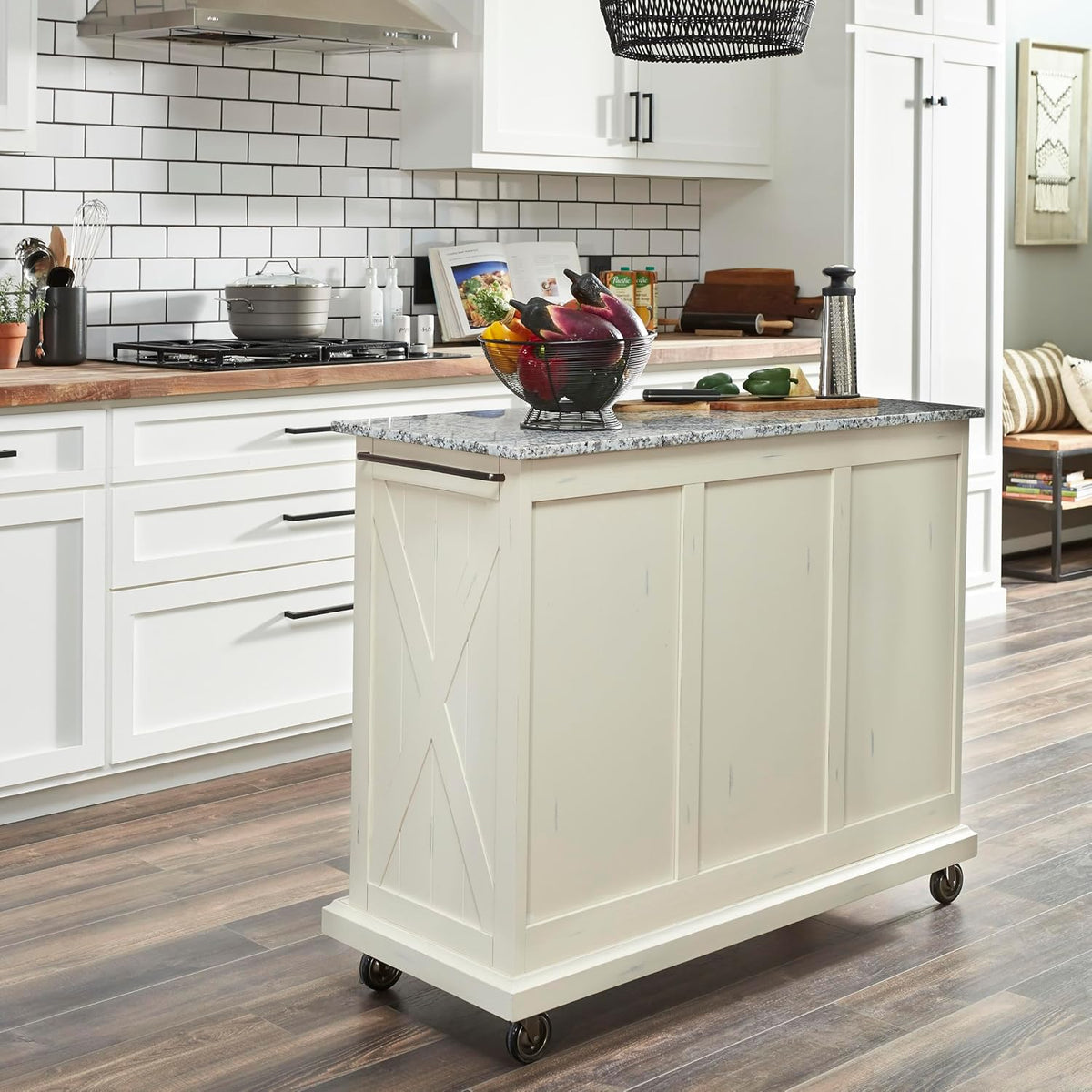 Rear three-quarter view of off-white island showing paneled back, side towel bar and swivel casters
