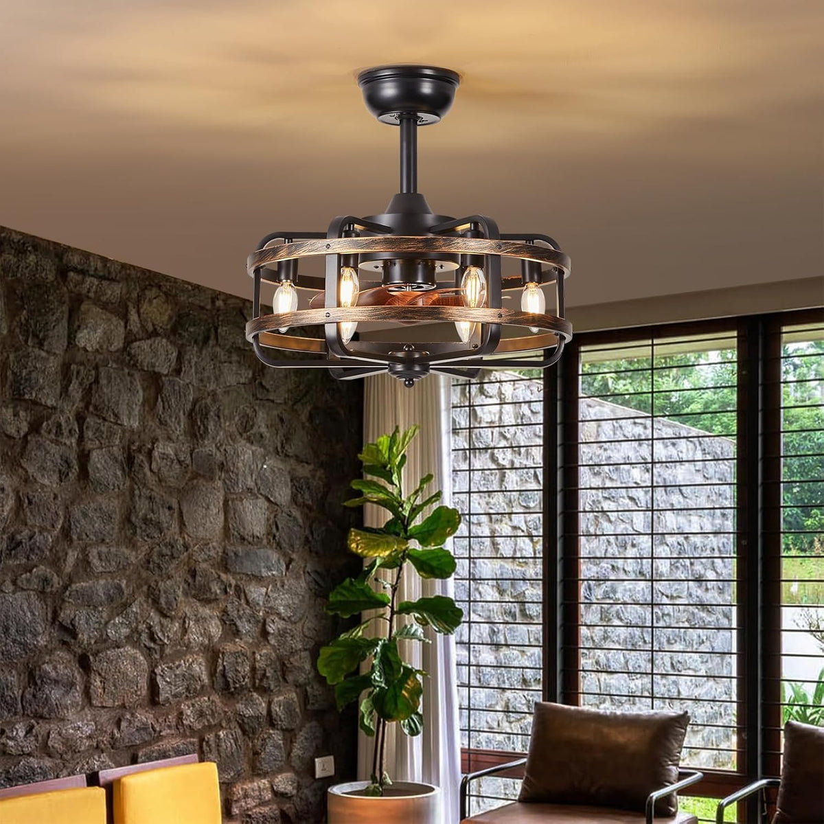 Mounted fan lit in a cozy living area with stone accent wall, tall plant, and window blinds in the background.