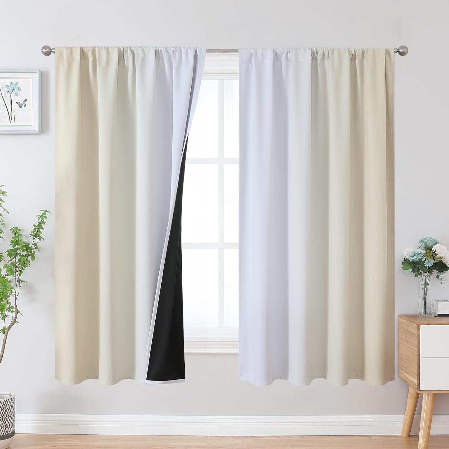Light beige and white ombre rod-pocket curtains hanging at window, one panel opened slightly to show black blackout lining