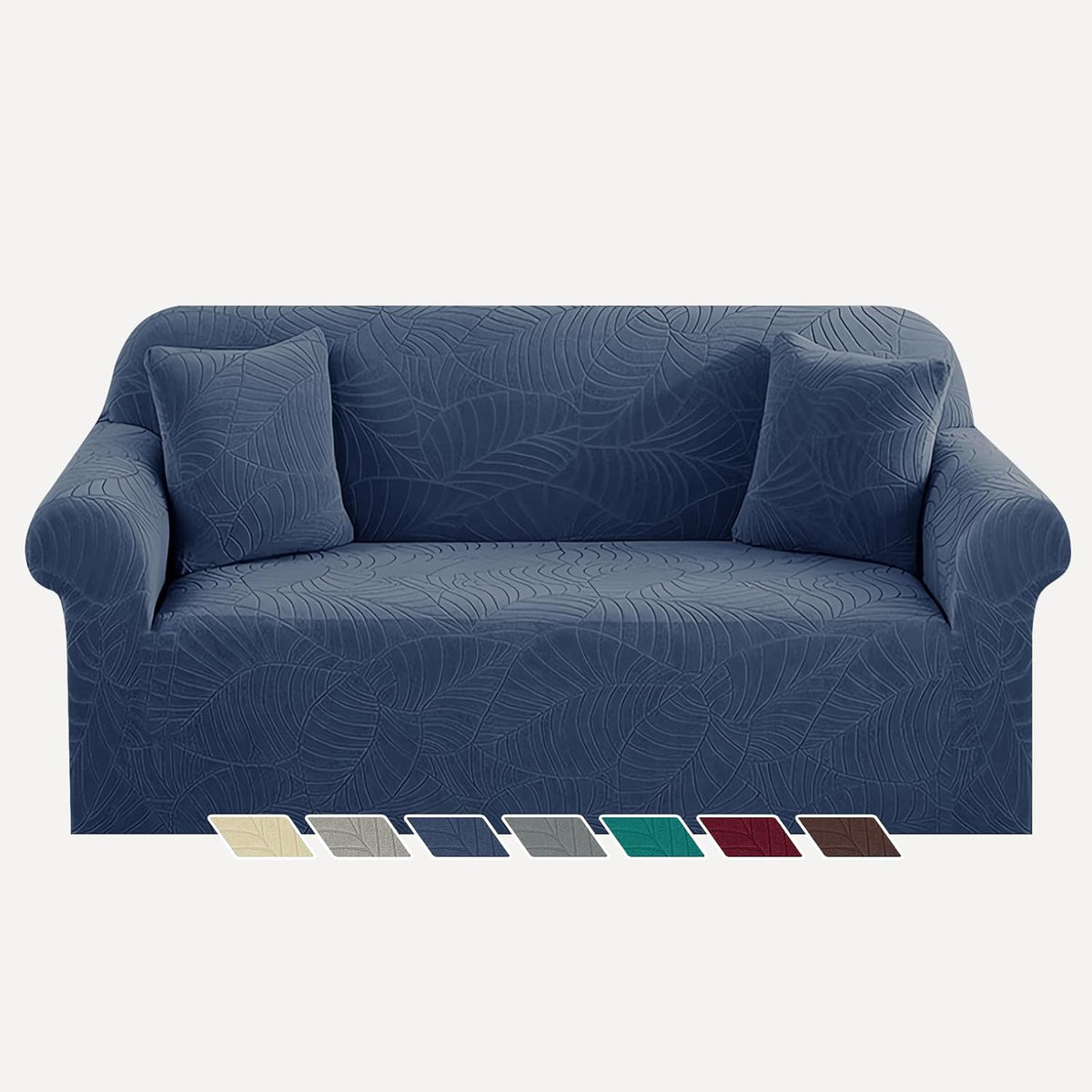 Blue leaf-patterned sofa cover shown on a two-cushion sofa with two matching pillows.