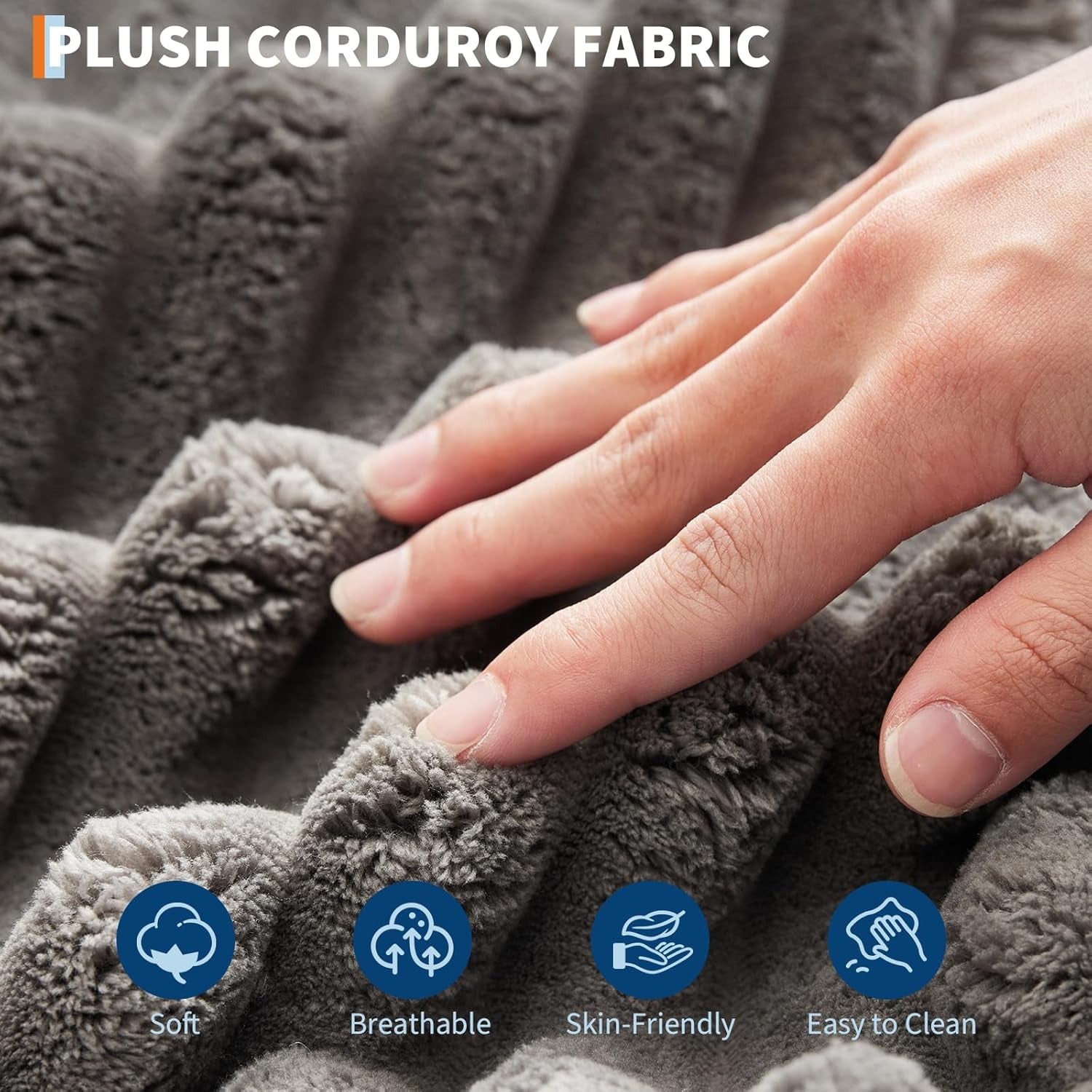 Hand touching plush grey corduroy fabric showing ribbed texture and soft pile