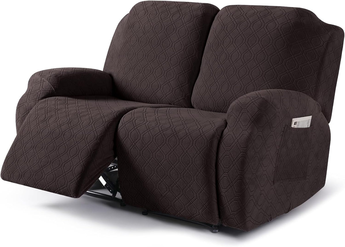 Recliner sofa covered in textured dark gray slipcover with left footrest extended and arm pocket visible.