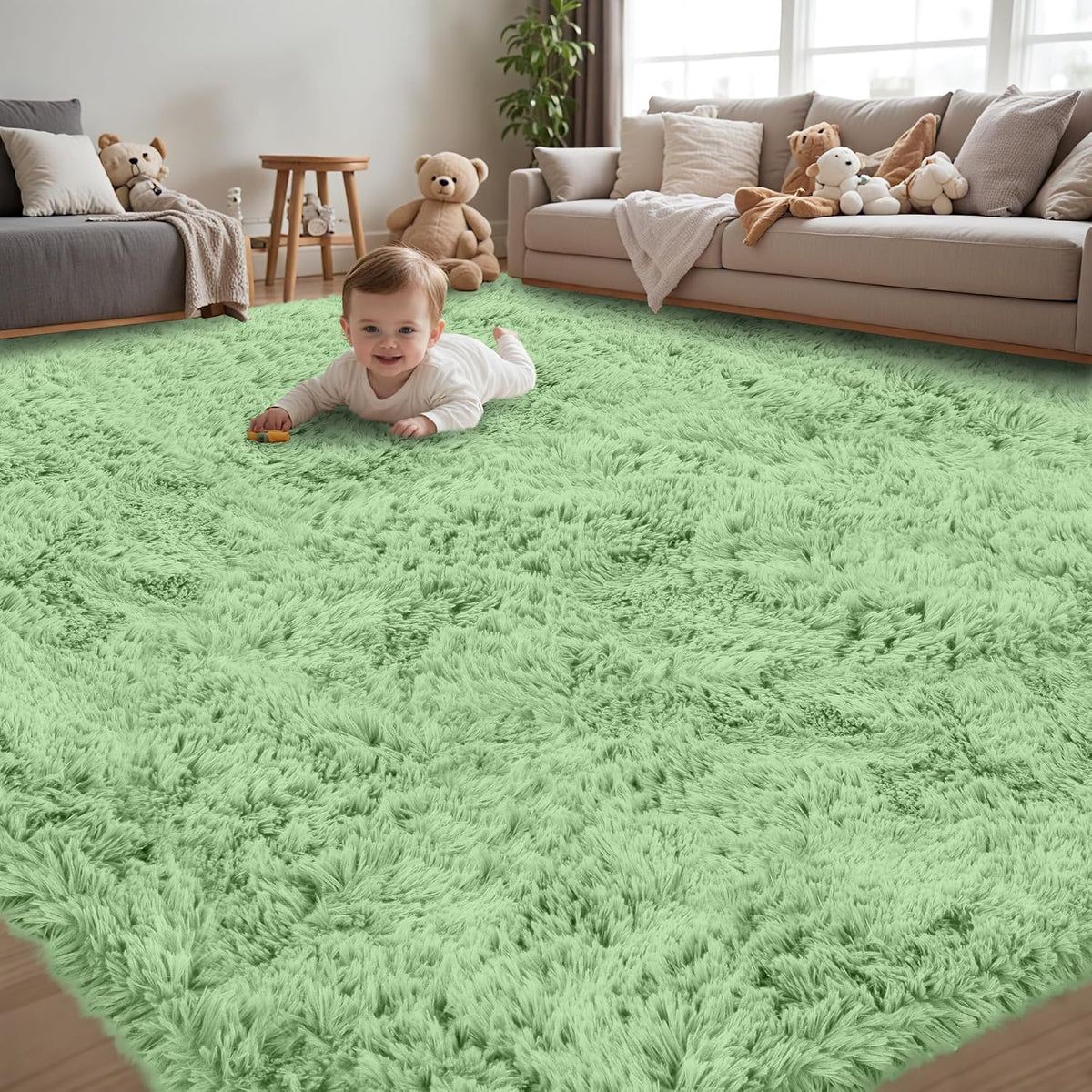 Smiling baby lying on a soft mint-green shag rug in a family room with couches and stuffed toys.