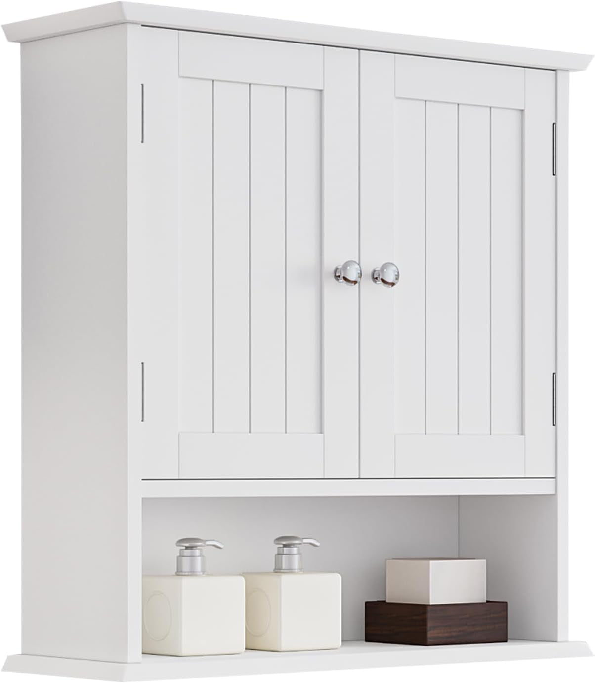 White wall-mounted bathroom cabinet with two paneled doors, chrome knobs and open bottom shelf with bottles.