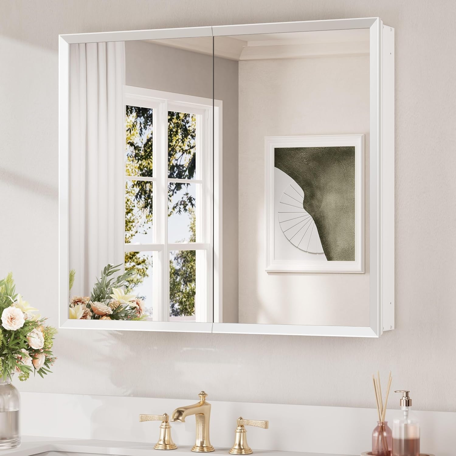Wall-mounted mirrored medicine cabinet with white frame and two mirrored doors over a vanity.