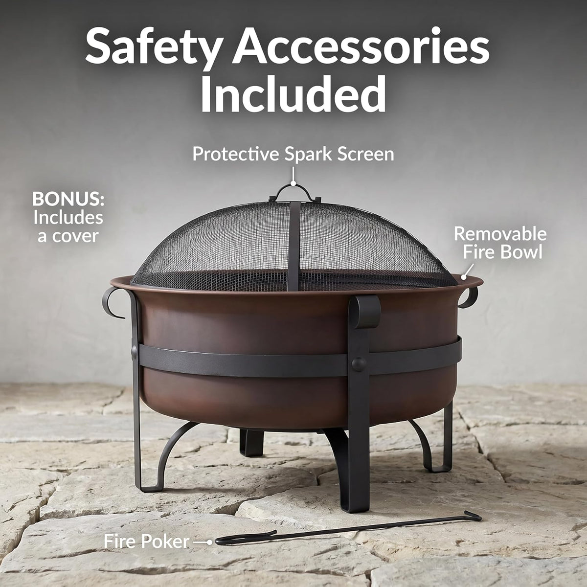 Round dark bronze fire pit with dome spark screen and black leg frame on a stone surface, angled side view