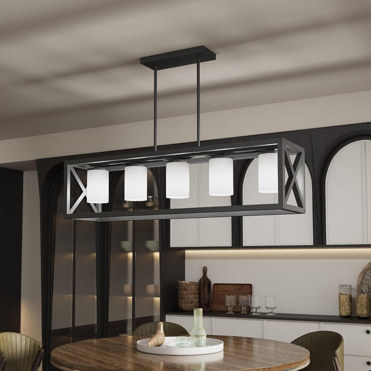 Close view of a black rectangular chandelier variant with six white cylindrical fabric shades above a wood table.