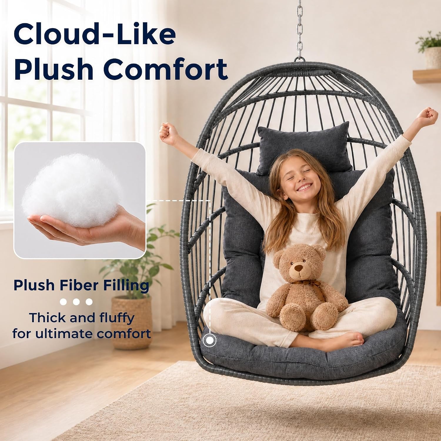 Hanging wicker chair shown indoors with a child seated and thick dark plush cushion and integrated headrest