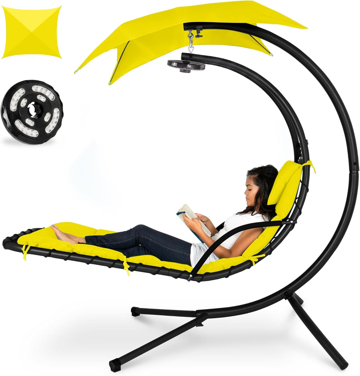 Curved hanging chaise with yellow cushions and canopy, woman reclining and reading a book