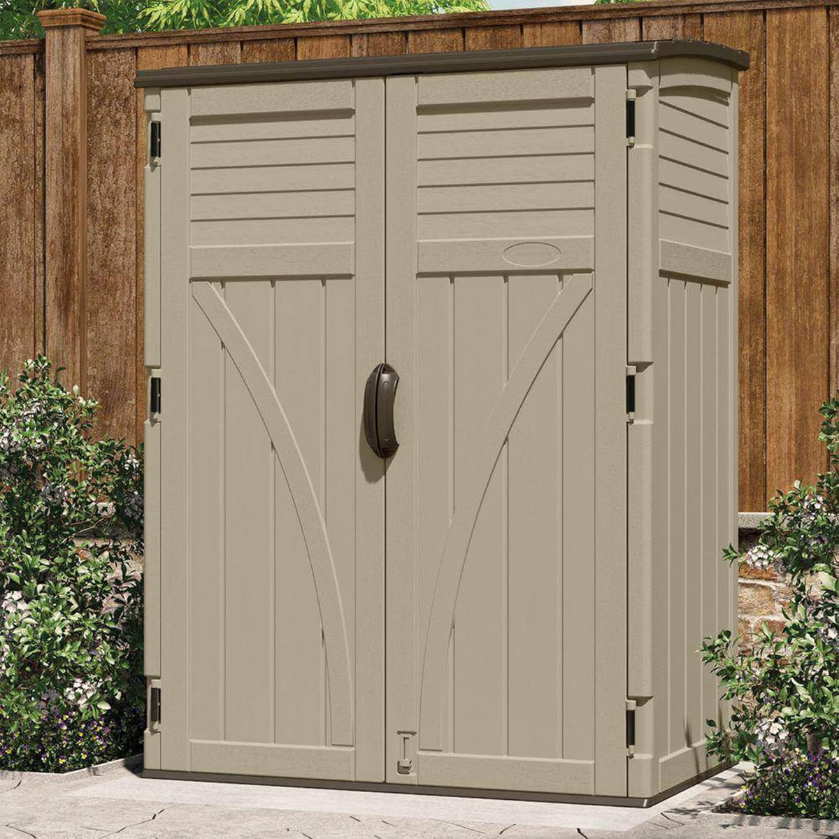 Taupe vertical storage cabinet placed on a patio against a wooden fence, front-facing view