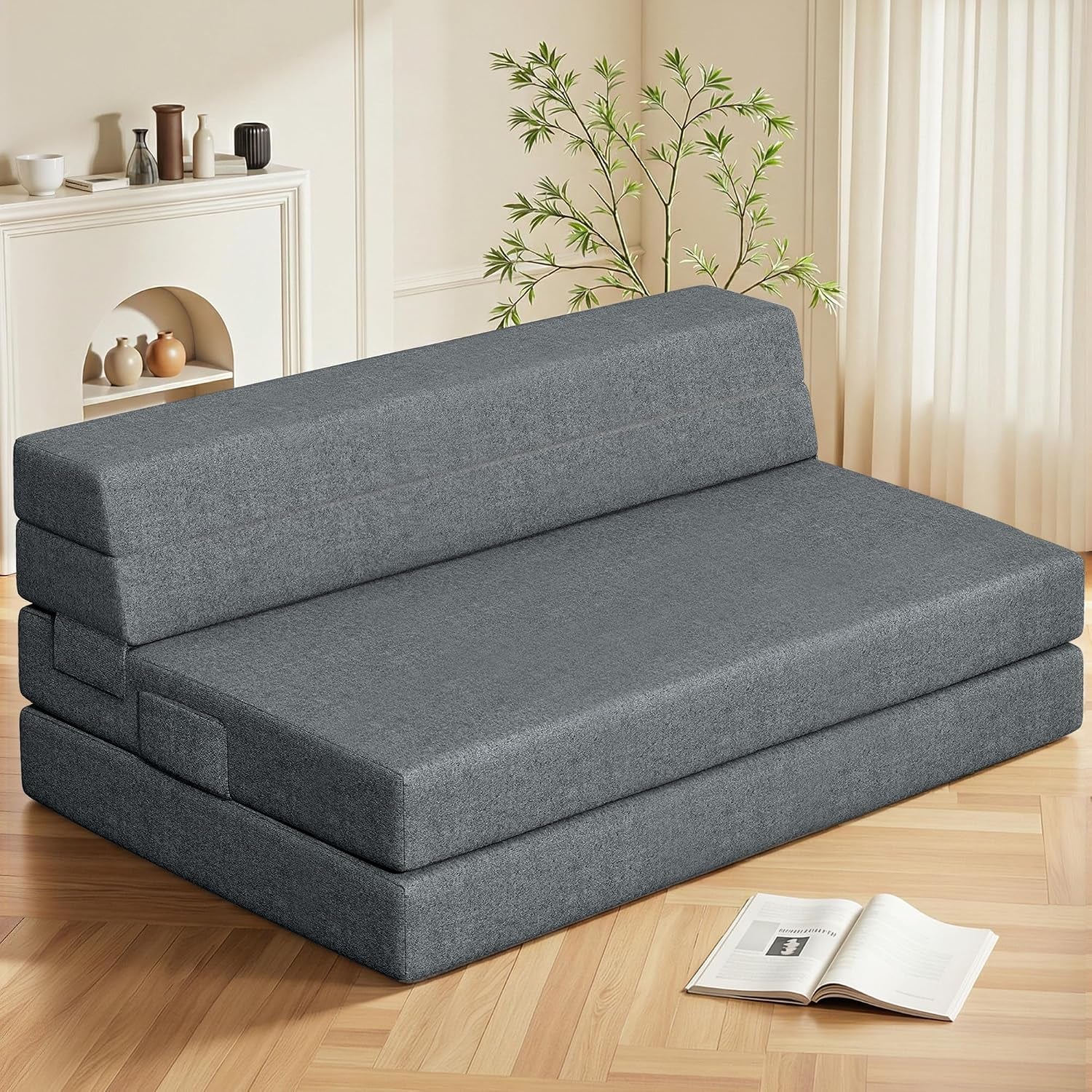 Dark gray folding foam mattress shown as a sofa configuration angled front view on hardwood floor