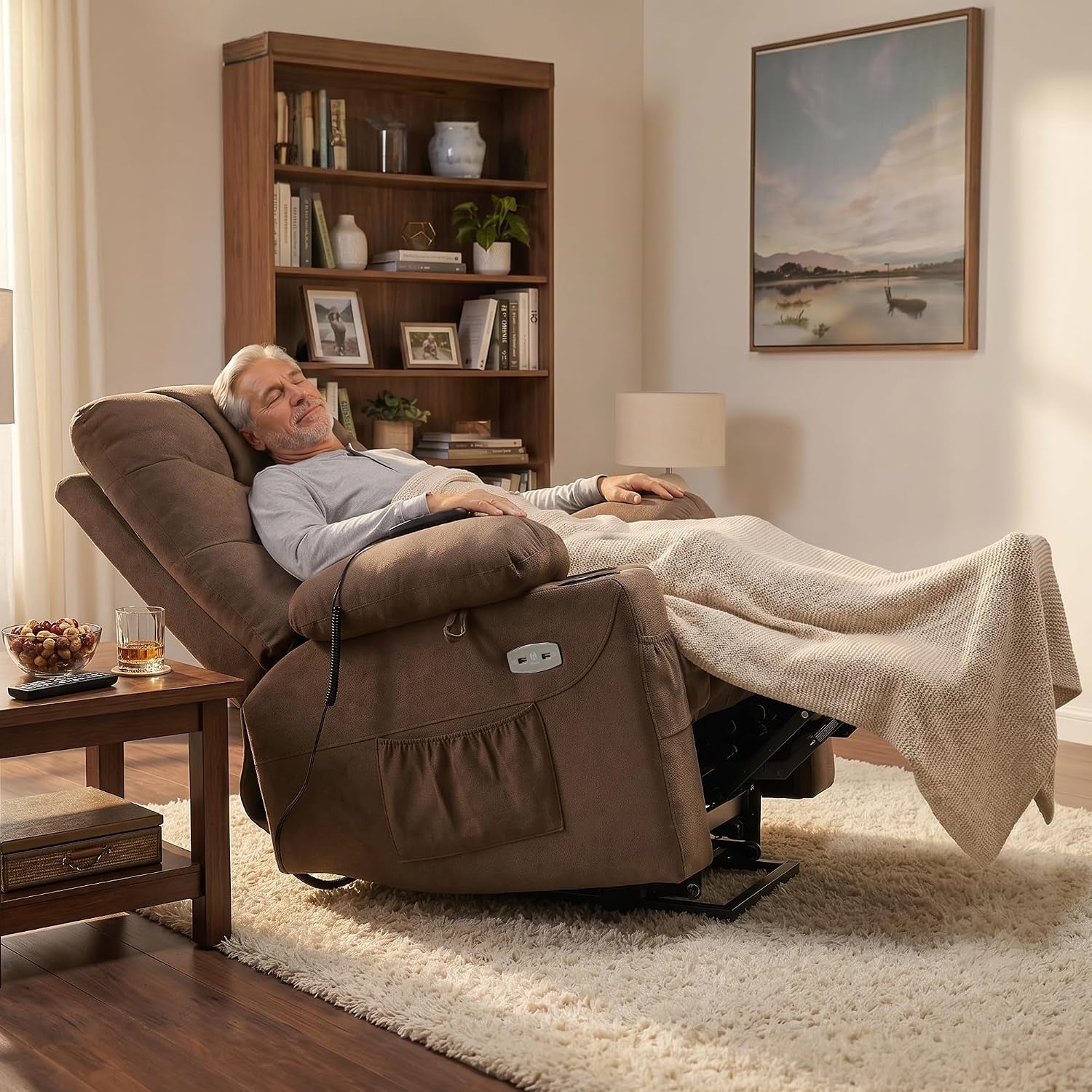 Brown power lift recliner fully reclined in a living room with a person resting under a throw blanket