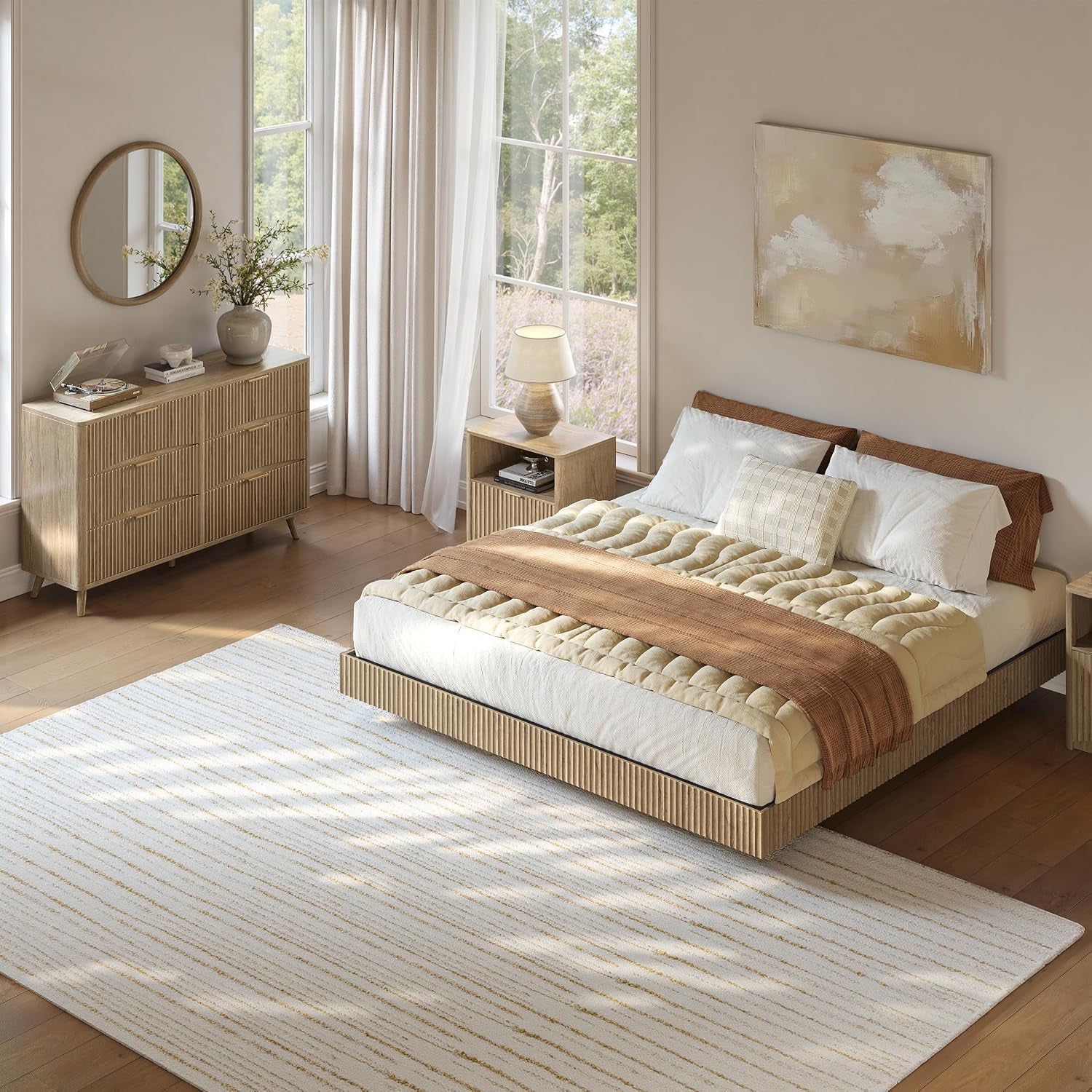 Angled view of the bedroom showing the bed, dresser, nightstand and large window with curtains.