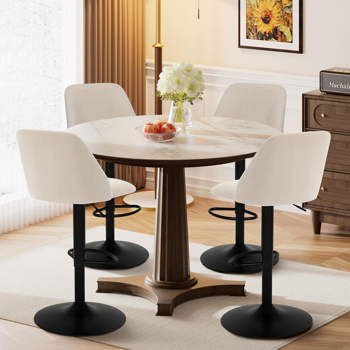 Four beige fabric bar stools arranged around a round dining table in a bright dining room setting