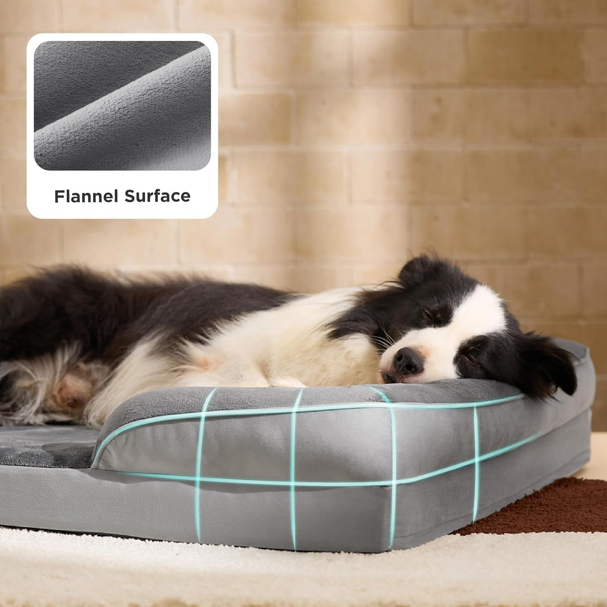 Black-and-white dog resting its head on a gray orthopedic bed with raised bolsters and turquoise grid accents.