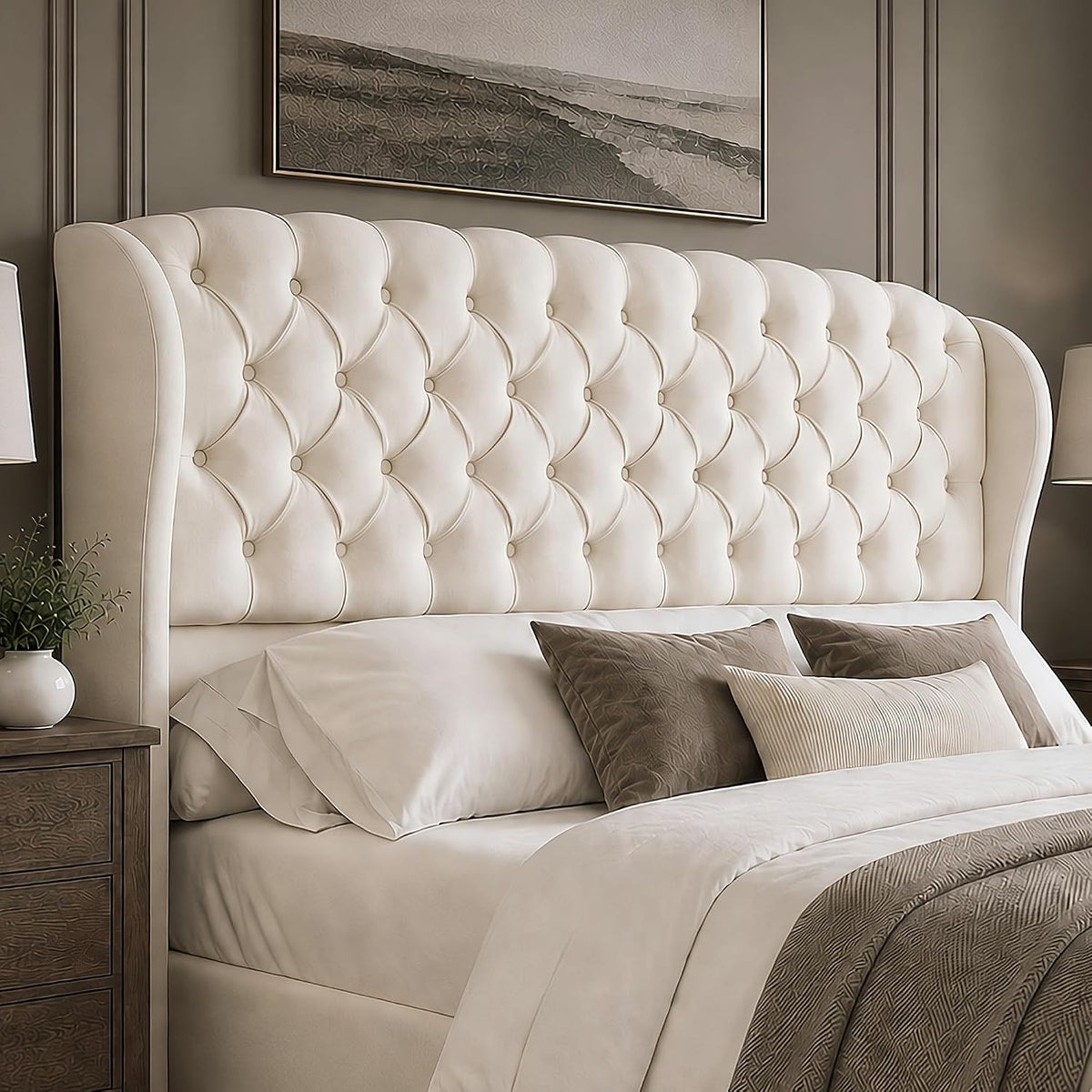 Cream-colored tufted wingback headboard in a warm bedroom setting with bedside tables