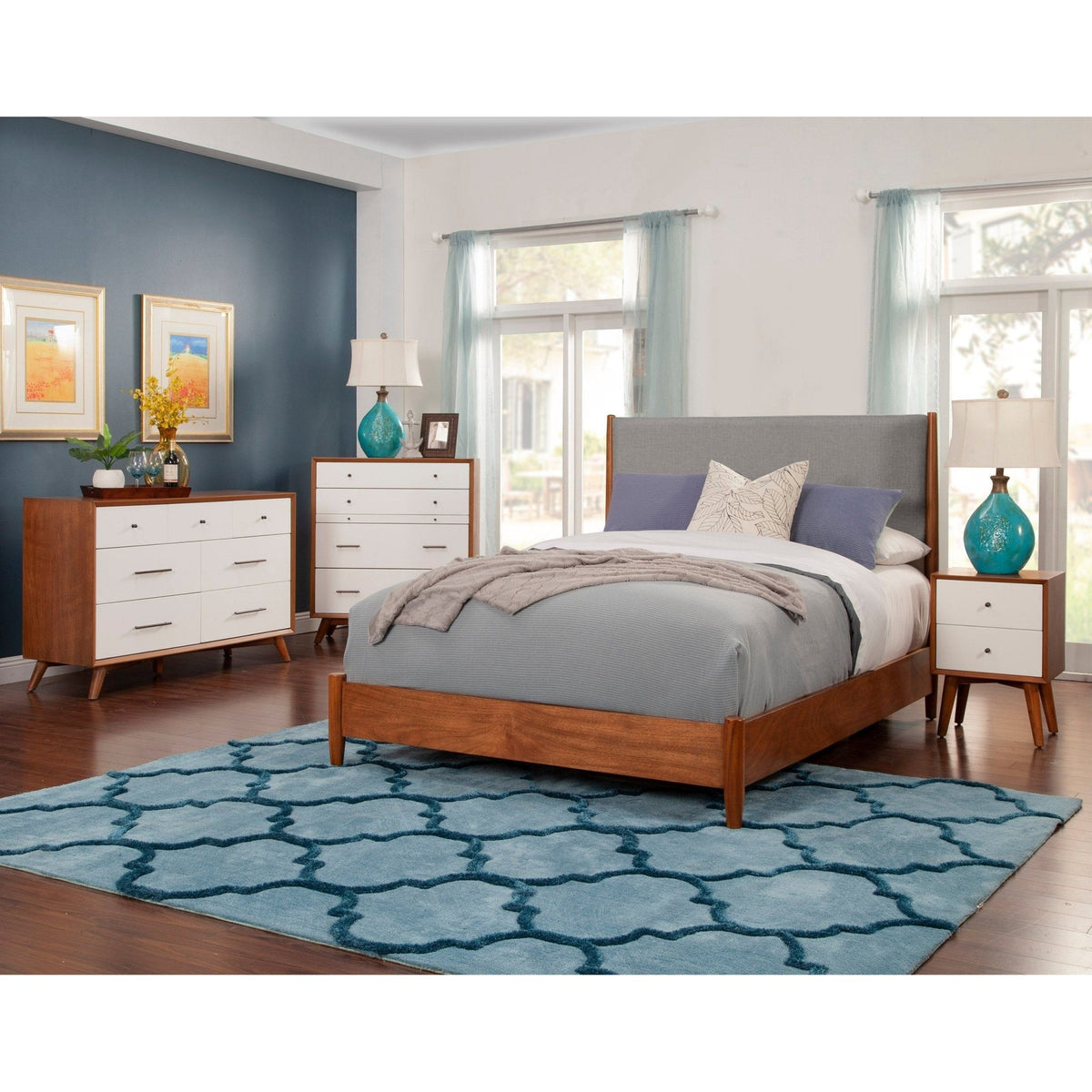 Bedroom scene with a bed and matching chestnut and white storage furniture