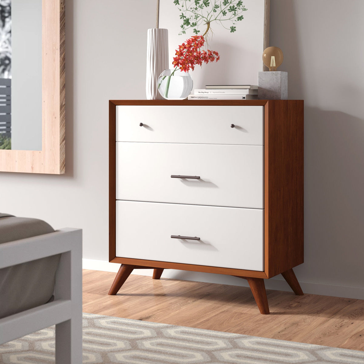 Chestnut-framed chest with three white drawers and angled legs in a bedroom setting.