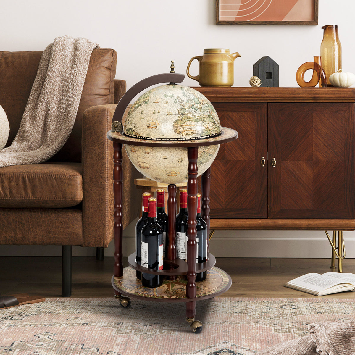 A wooden globe bar cart stocked with bottles stands beside a brown sofa and cabinet.