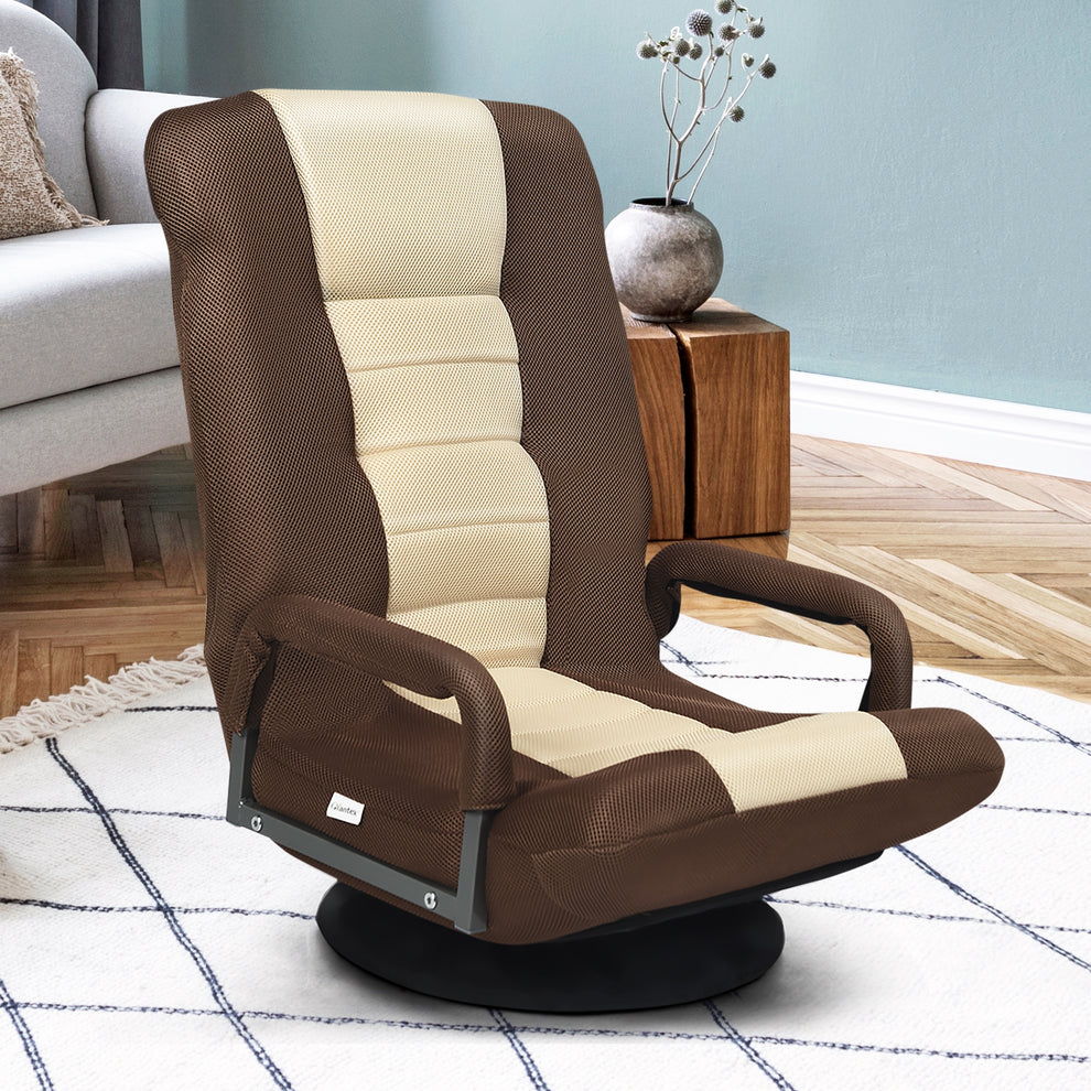 Brown and cream floor chair with padded arms on a black swivel base, shown in a living room.