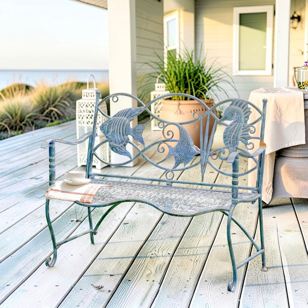 Coastal blue iron garden bench with fish backrest on a sunlit porch