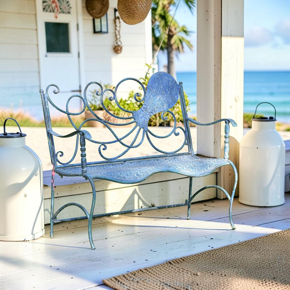 Distressed blue octopus garden bench on a bright covered porch, angled front view