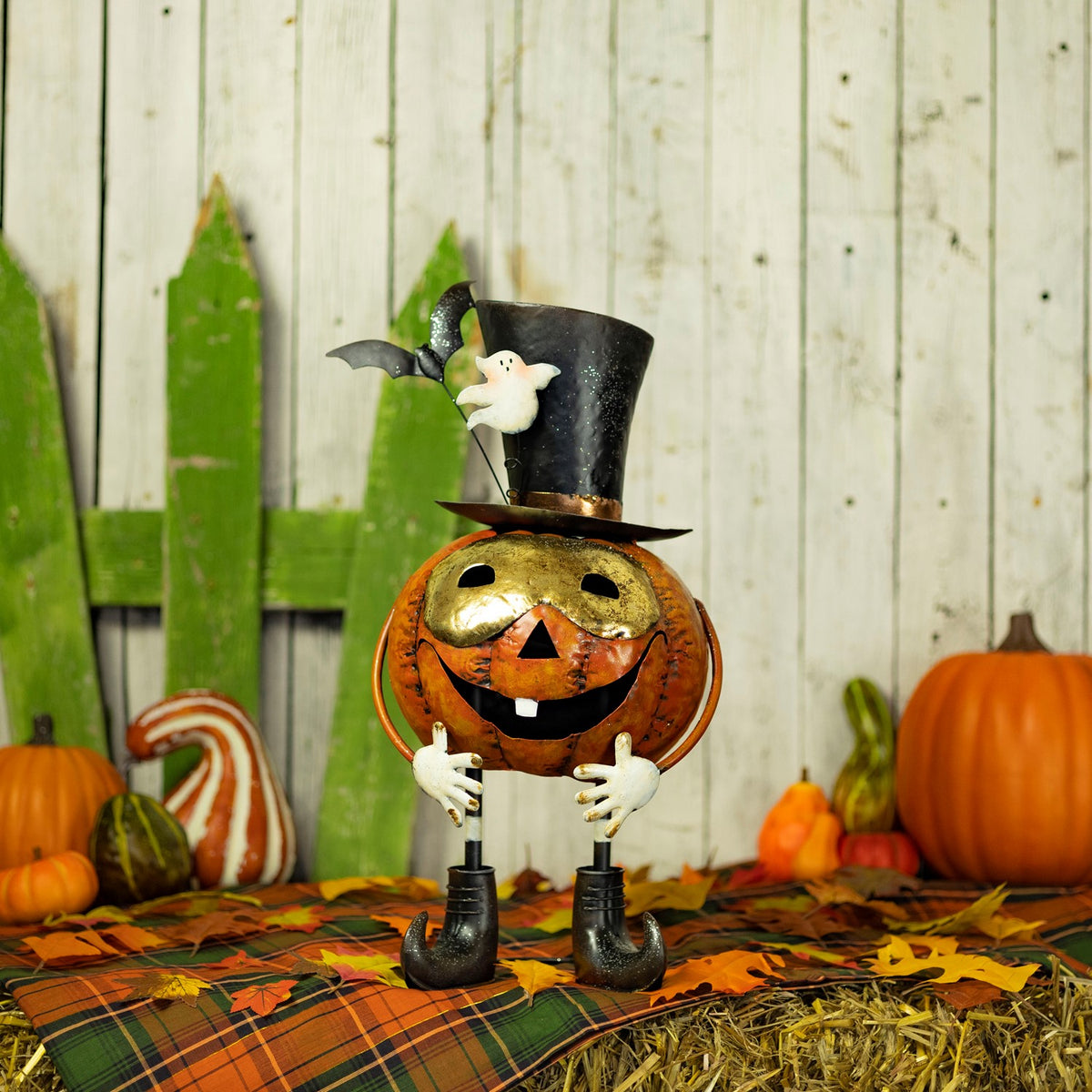Full view of an orange pumpkin figurine with a tall black hat in a Halloween display