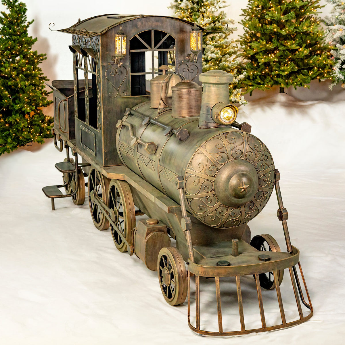 Vintage-style iron Christmas train with cart, angled front view among holiday trees