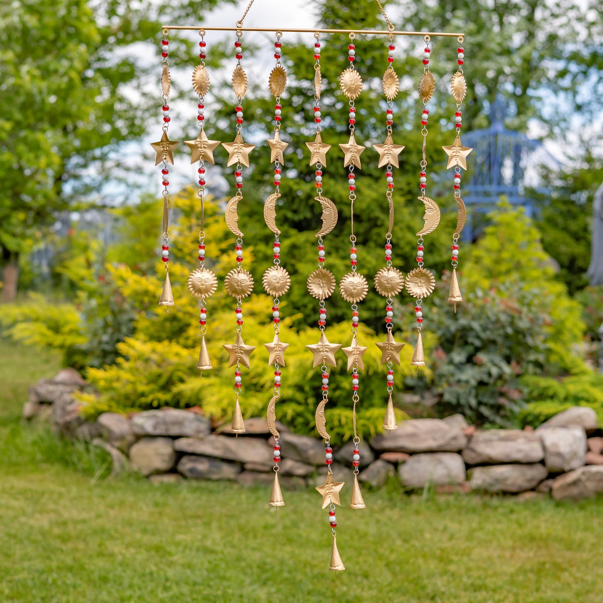 Gold-toned hanging chime with dangling stars, crescents, sunbursts, beads, and bell-shaped ends.