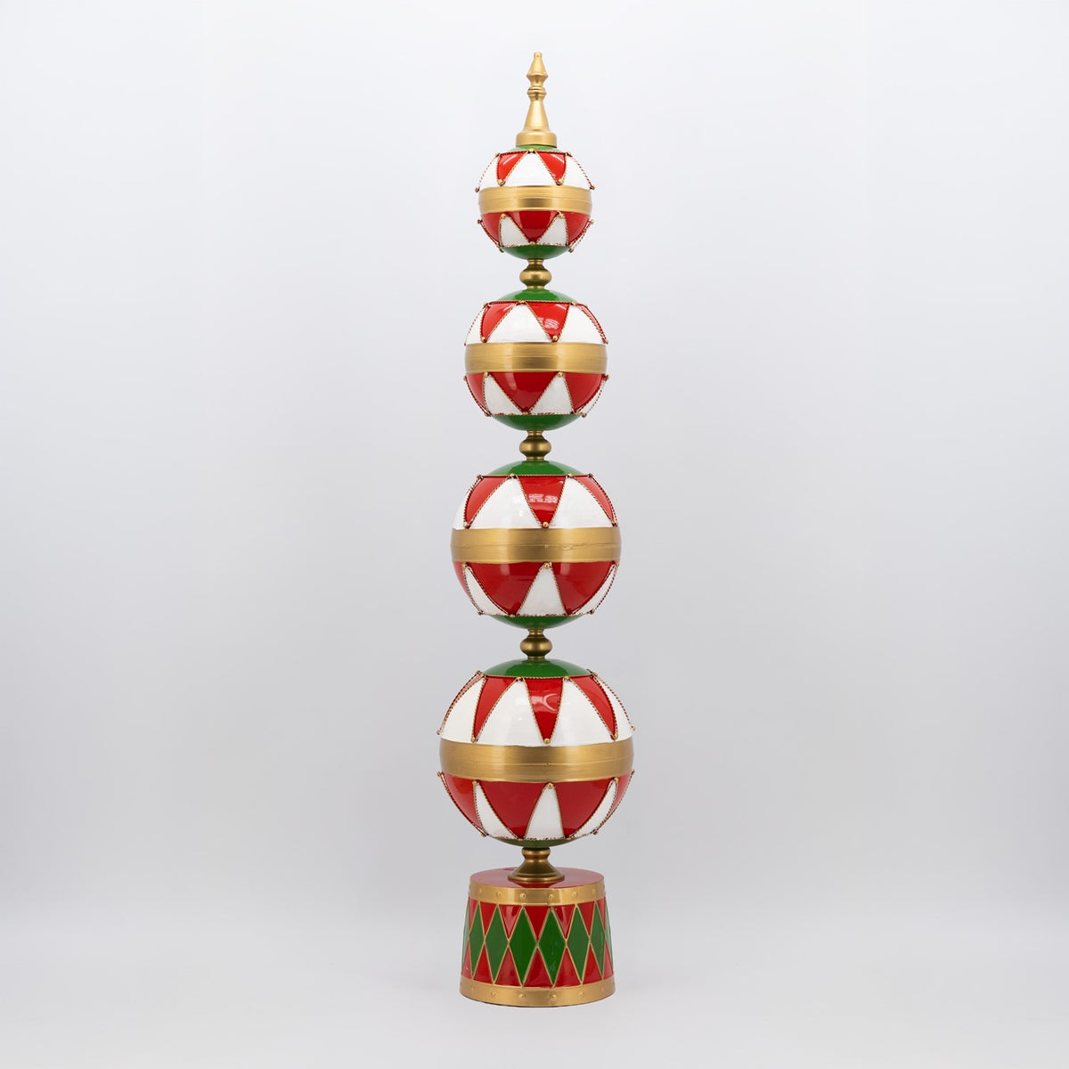 Full view of a tall tower with four red-and-white striped ornaments, gold bands, and a patterned base.