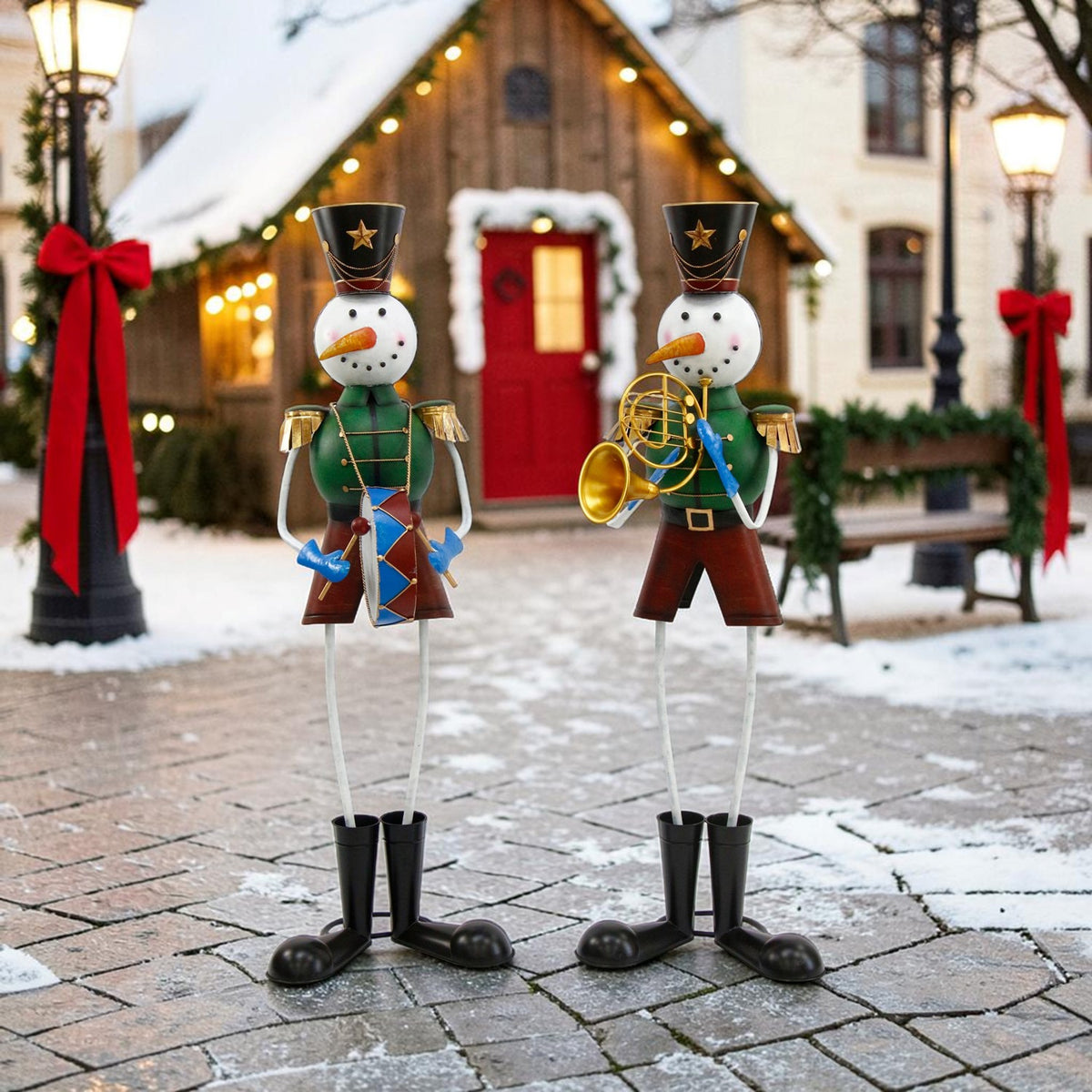 Two snowman soldiers stand on a snowy path in front of a warmly lit cottage.