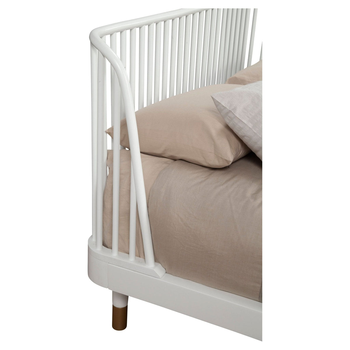 Close-up of the white slat-back headboard and gold-finished bed leg