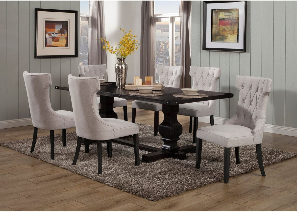 Light grey tufted dining chairs around a dark dining table in a room