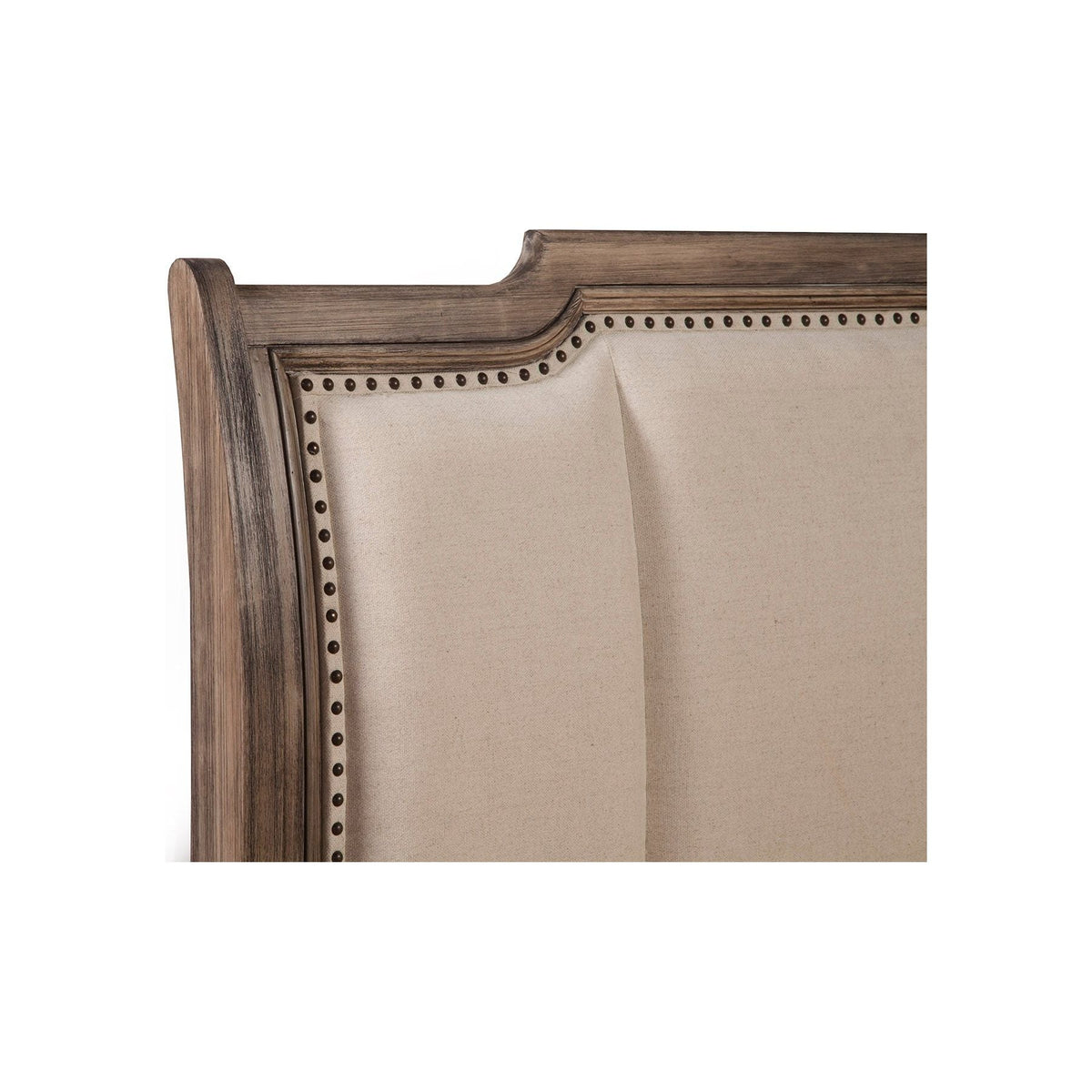 Close-up of the upholstered headboard with nailhead trim and wood frame